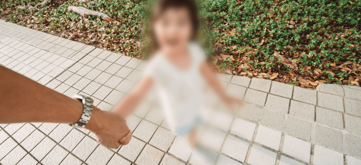 Example image of someone holding a child's hand with blurry vision.